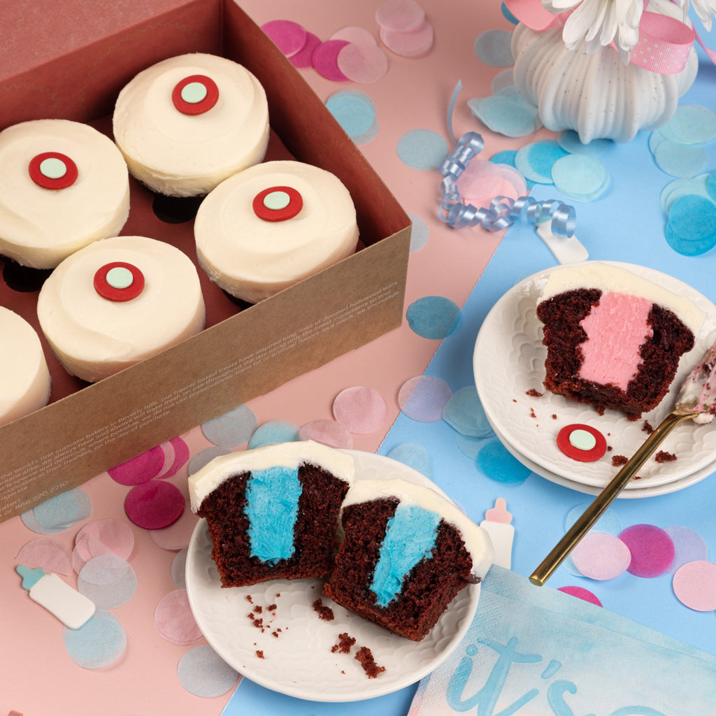 gender reveal box of cupcakes with blue and pink vanilla buttercream filling