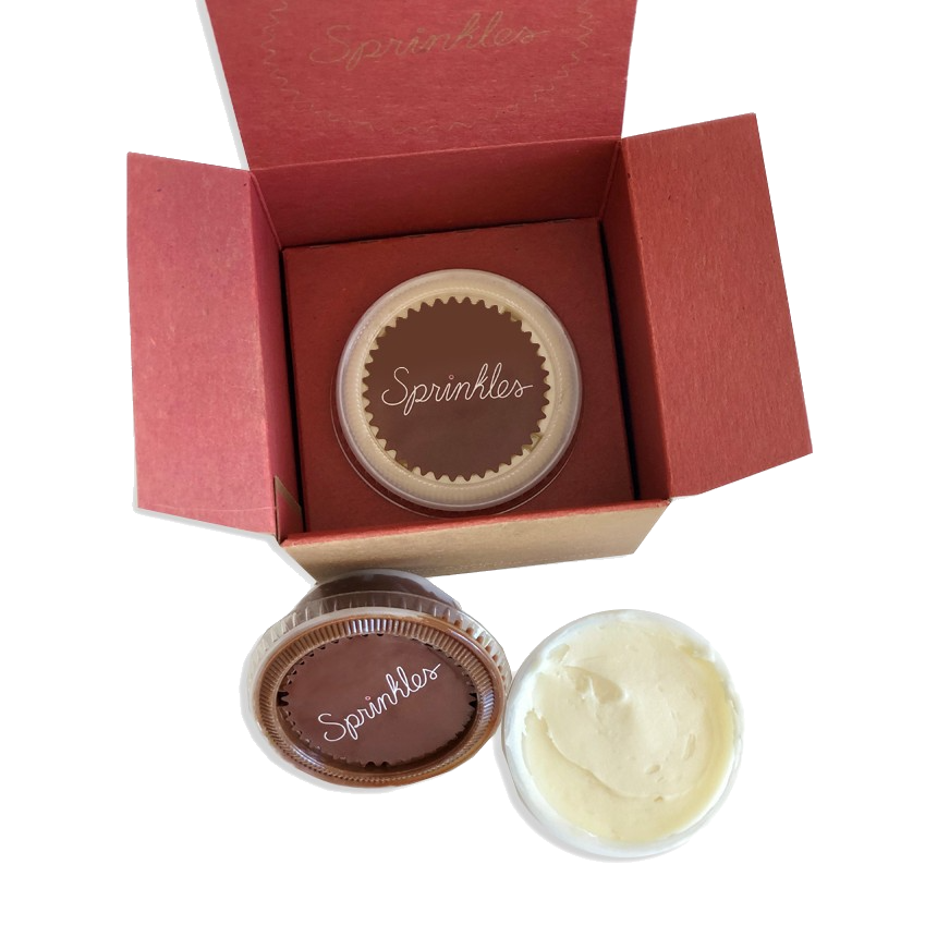Pack of three individually packaged frosting shots: cream cheese, dark chocolate buttercream, and vanilla buttercream.