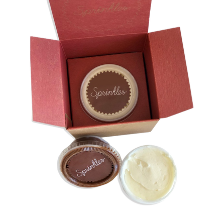 Pack of three individually packaged frosting shots: cream cheese, dark chocolate buttercream, and vanilla buttercream.