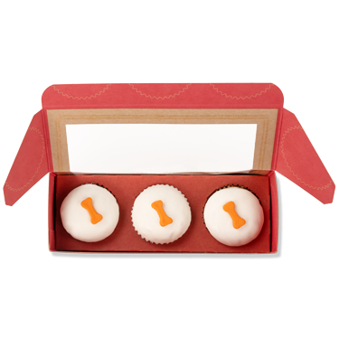 3 pupcakes in box open for viewing. not-bg